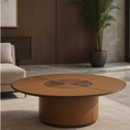 Load image into Gallery viewer, A round low coffee table with a warm brown leather base and a matching wood-grain top featuring a central geometric inlay, set in a modern living room.
