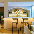 Load image into Gallery viewer, Modern restaurant interior with bar and seating area, featuring London bar stool
