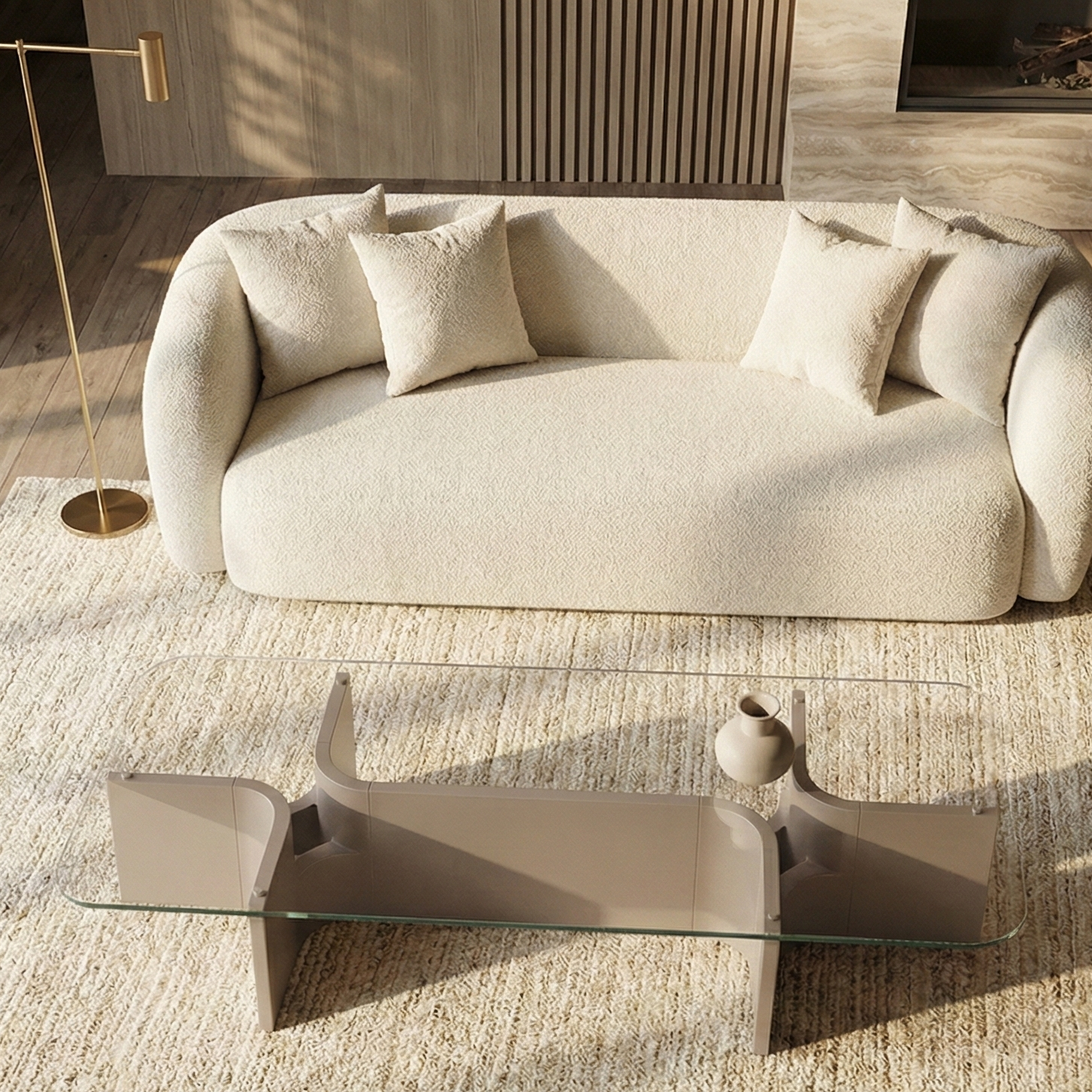 Modern living room with a beige sofa and a glass coffee table on a wooden floor.