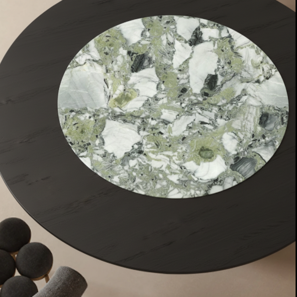 Round marble coaster with green and white pattern on a black rim