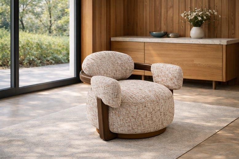 Modern armchair in a room with wooden floor and large windows
