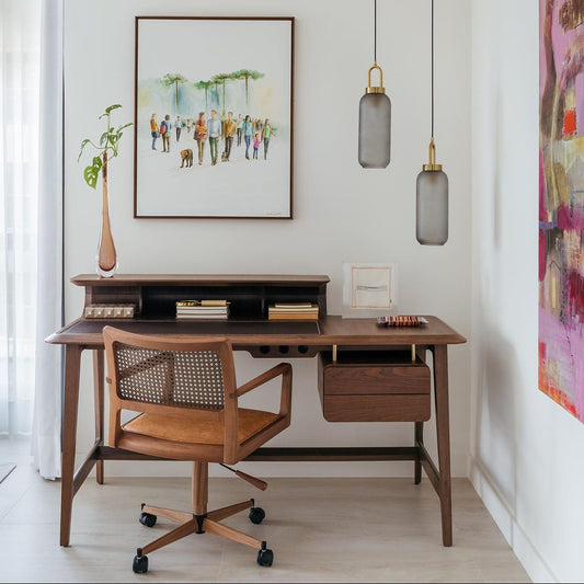 Modern home office with wooden desk, chair, and wall art