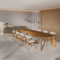 Load image into Gallery viewer, Modern dining area with a long wooden table and chairs in a minimalistic setting.
