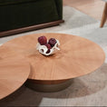 Charger l'image dans la visionneuse de la galerie, Round wooden coffee table with decorative items in a living room setting.
