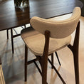 Load image into Gallery viewer, Dining table with a vase of yellow roses and a chair in a modern interior setting.
