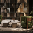 Load image into Gallery viewer, Modern interior with green armchairs, a round coffee table, and a textured wall.
