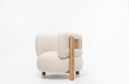 Charger l'image dans la visionneuse de la galerie, A modern low-profile accent chair upholstered in a textured off-white fabric, featuring a light natural wood frame and legs, set against a seamless white studio background.
