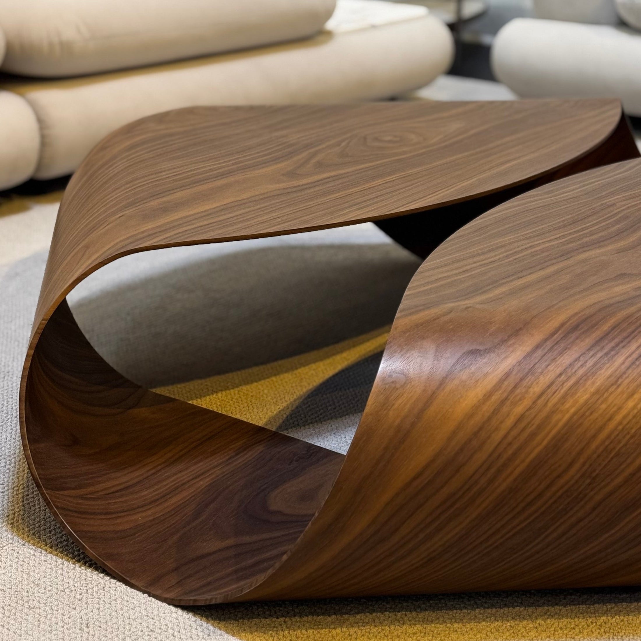 Modern wooden coffee table in a living room setting with neutral decor