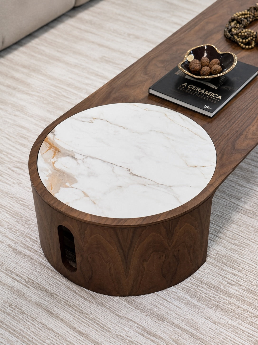 Wooden coffee table with marble top on a light wood floor