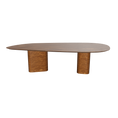 Load 3D model into Gallery viewer, A contemporary design dining table with a smooth, oval-shaped wood tabletop, supported by two cylindrical legs.
