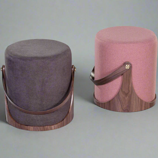 Two cylindrical ottomans with wooden bases on a white background